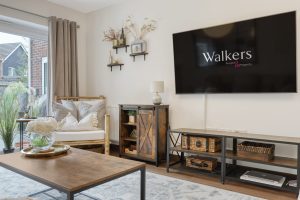 Living room with sofa, coffee table and wall-mounted TV