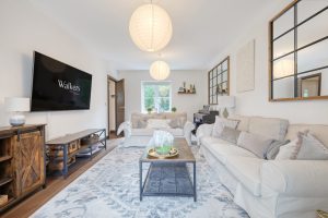 Long living room with sofas and pendant lights