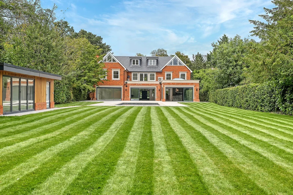 Red-brick country house with a striped lawn
